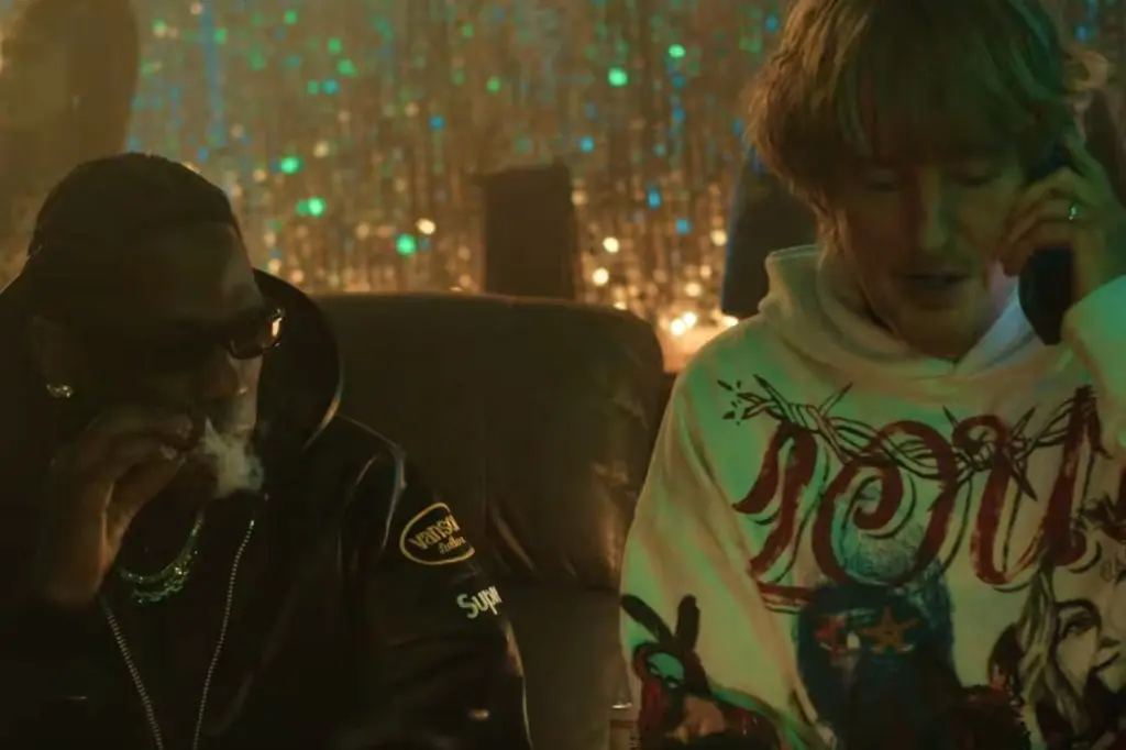 Watch Travis Scott & Sexyy Red Help Owen Wilson Search for His Son in Chaotic ‘Rolling Loud’ Movie Trailer